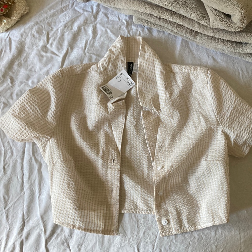 off-white cropped button up shirt.
